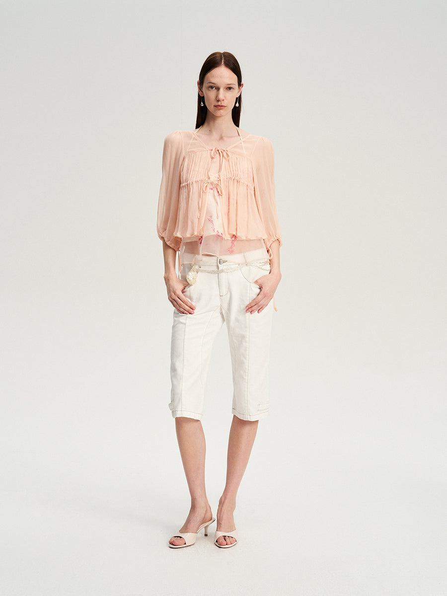 Dotyears silk tulle over a pale pink strappy cardigan