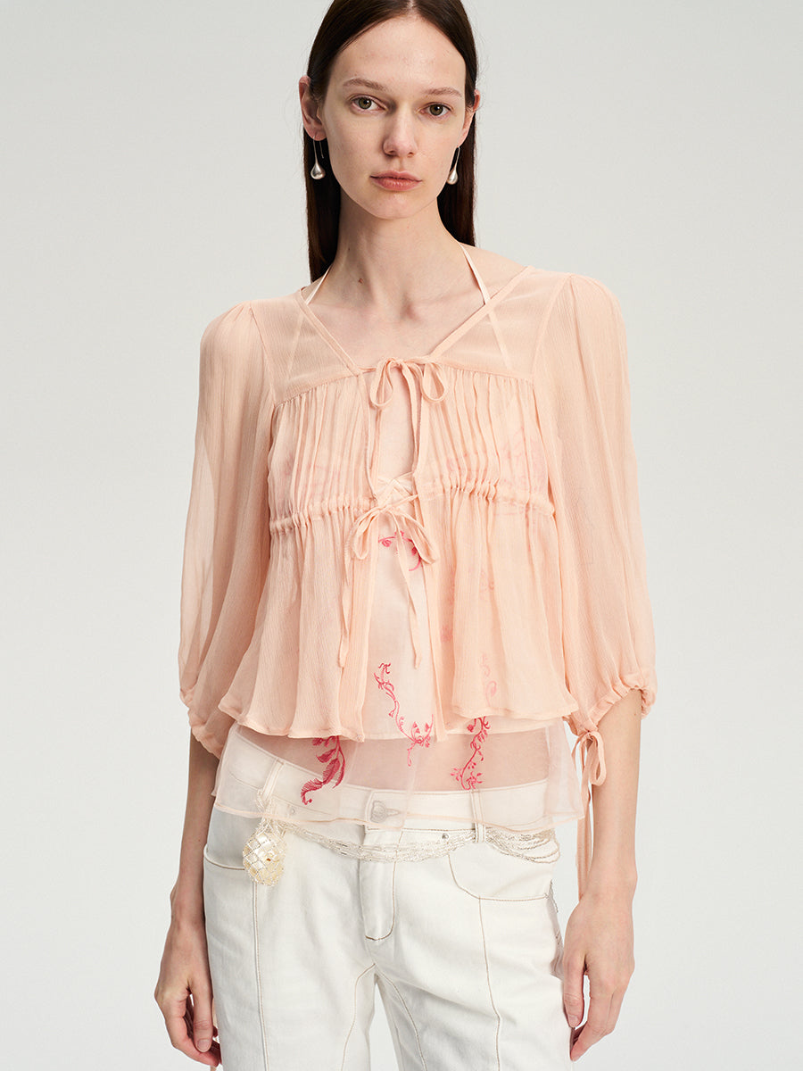 Dotyears silk tulle over a pale pink strappy cardigan