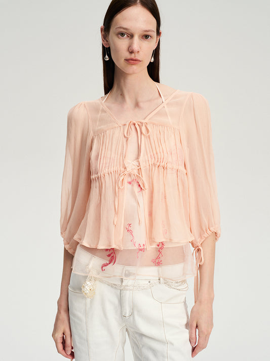 Dotyears silk tulle over a pale pink strappy cardigan