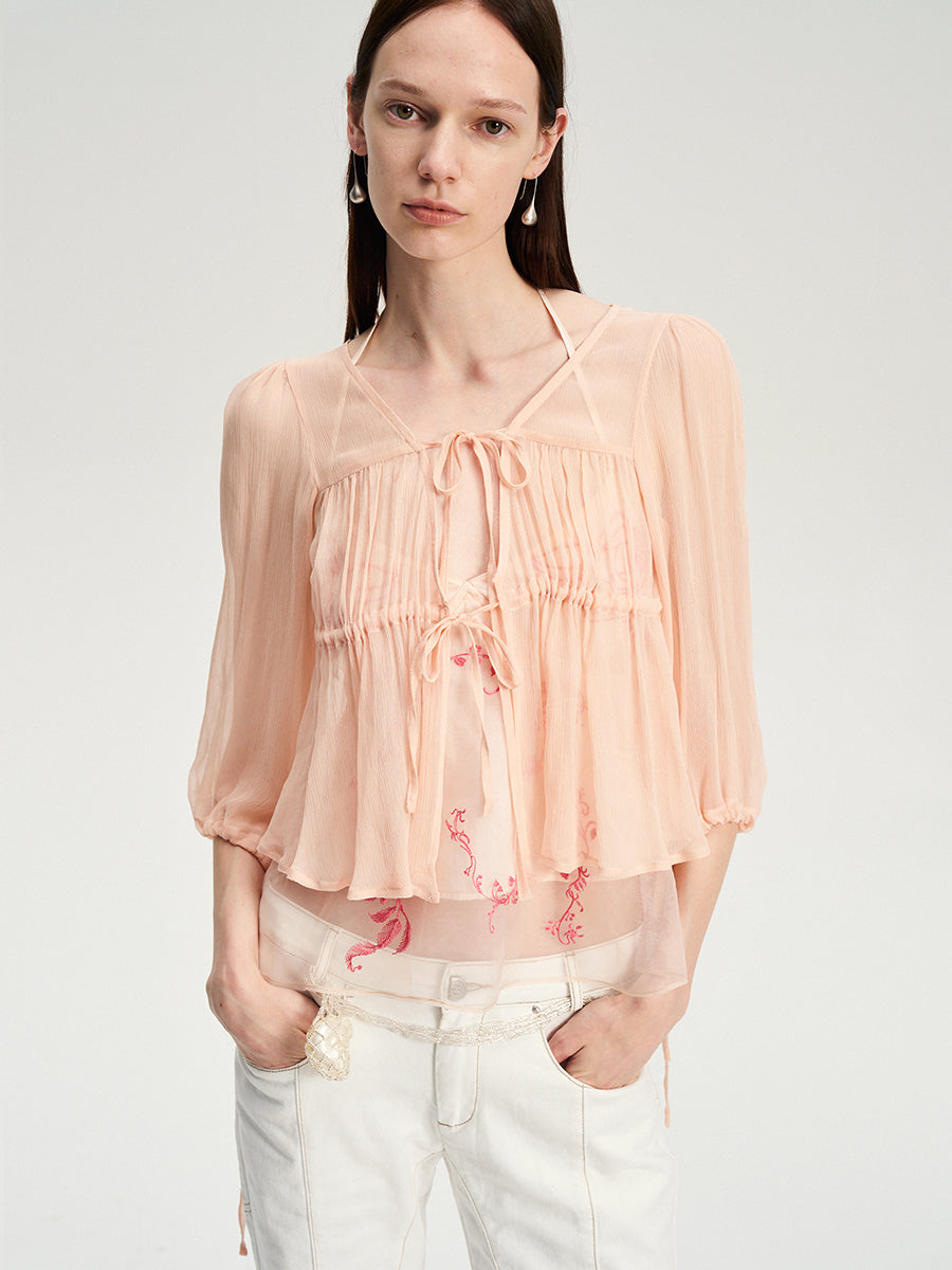 Dotyears silk tulle over a pale pink strappy cardigan
