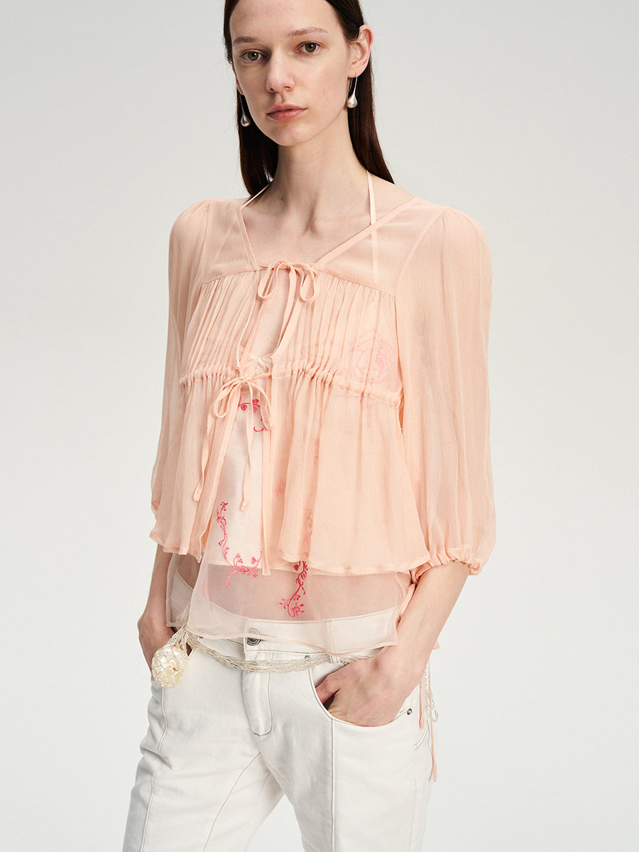 Dotyears silk tulle over a pale pink strappy cardigan