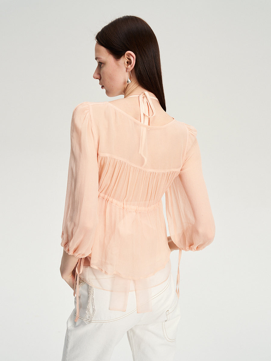 Dotyears silk tulle over a pale pink strappy cardigan